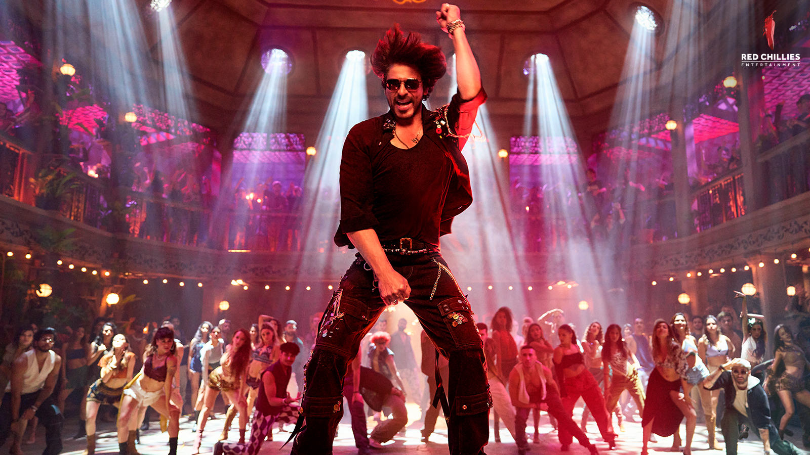 Shah Rukh Khan dancing in Jawan, with a crowd dancing behind him
