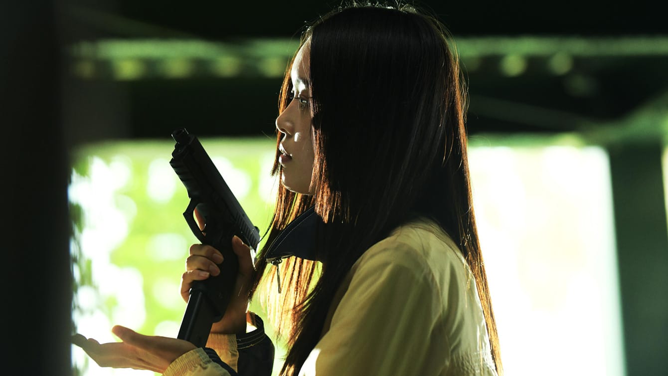 Akari Takaishi loads a pistol in Baby Assassins 3