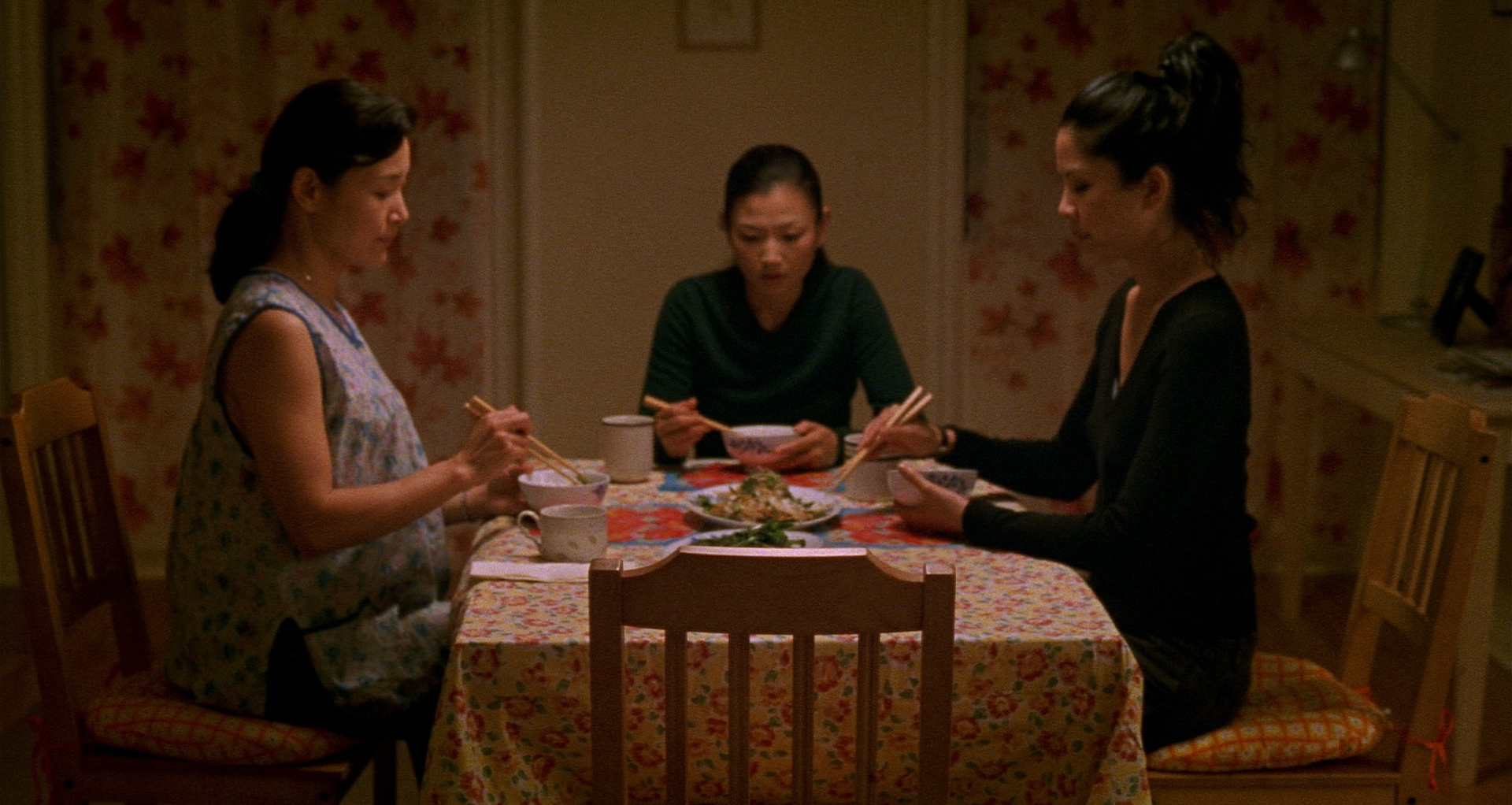 The three main characters in Saving Face sit around the dinner table