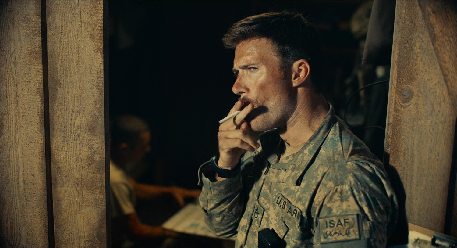 Scott Eastwood, in army fatigues, takes a drag from a cigarette in The Outpost