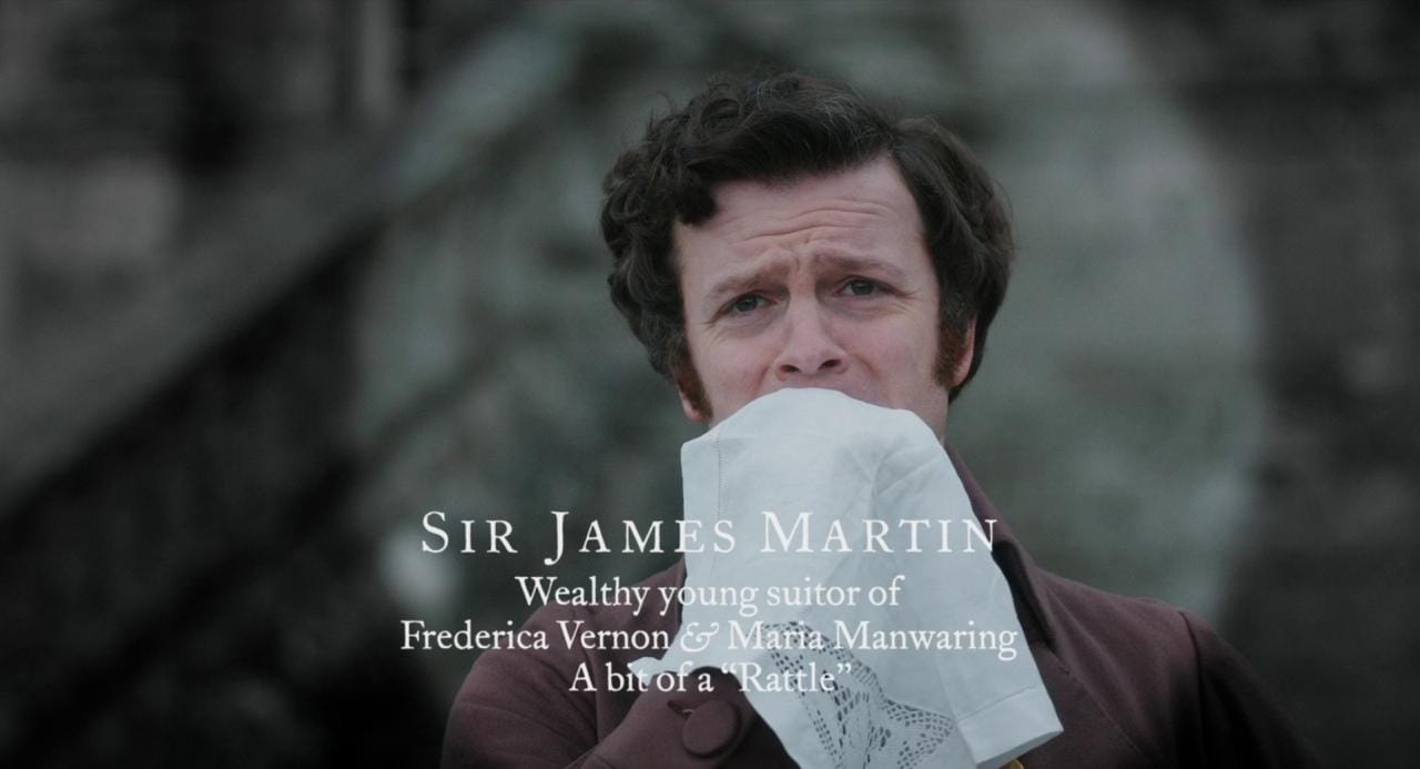 Spotlight introduction of Sir James Martin in Love & Friendship. As he covers his mouth with a handkerchief, text displays "Sir James Martin. Wealthy young suitor of Frederica Vernon & Maria Manwaring. A bit of a "Rattle."