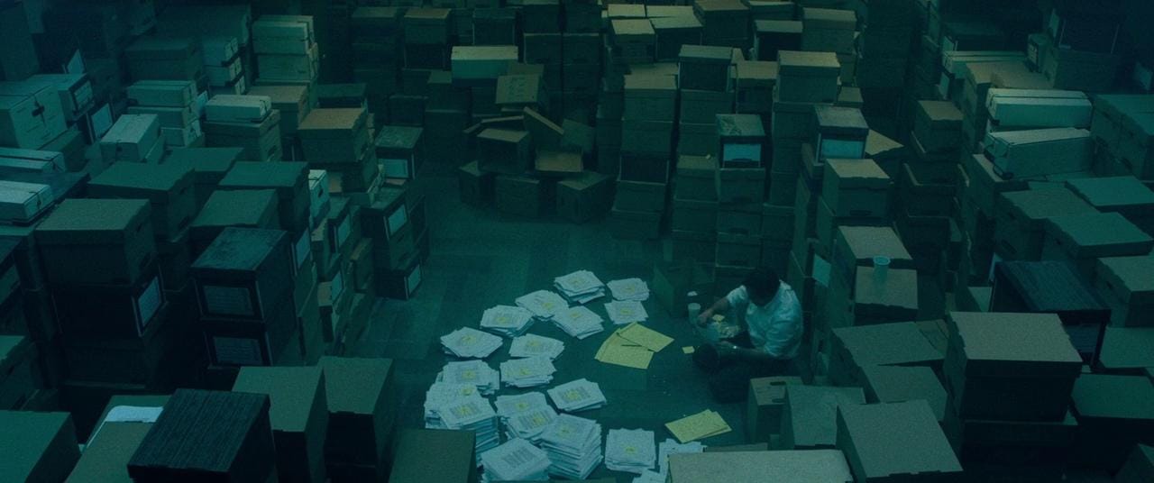 Mark Ruffalo surrounded by piles of paperwork in Dark Waters