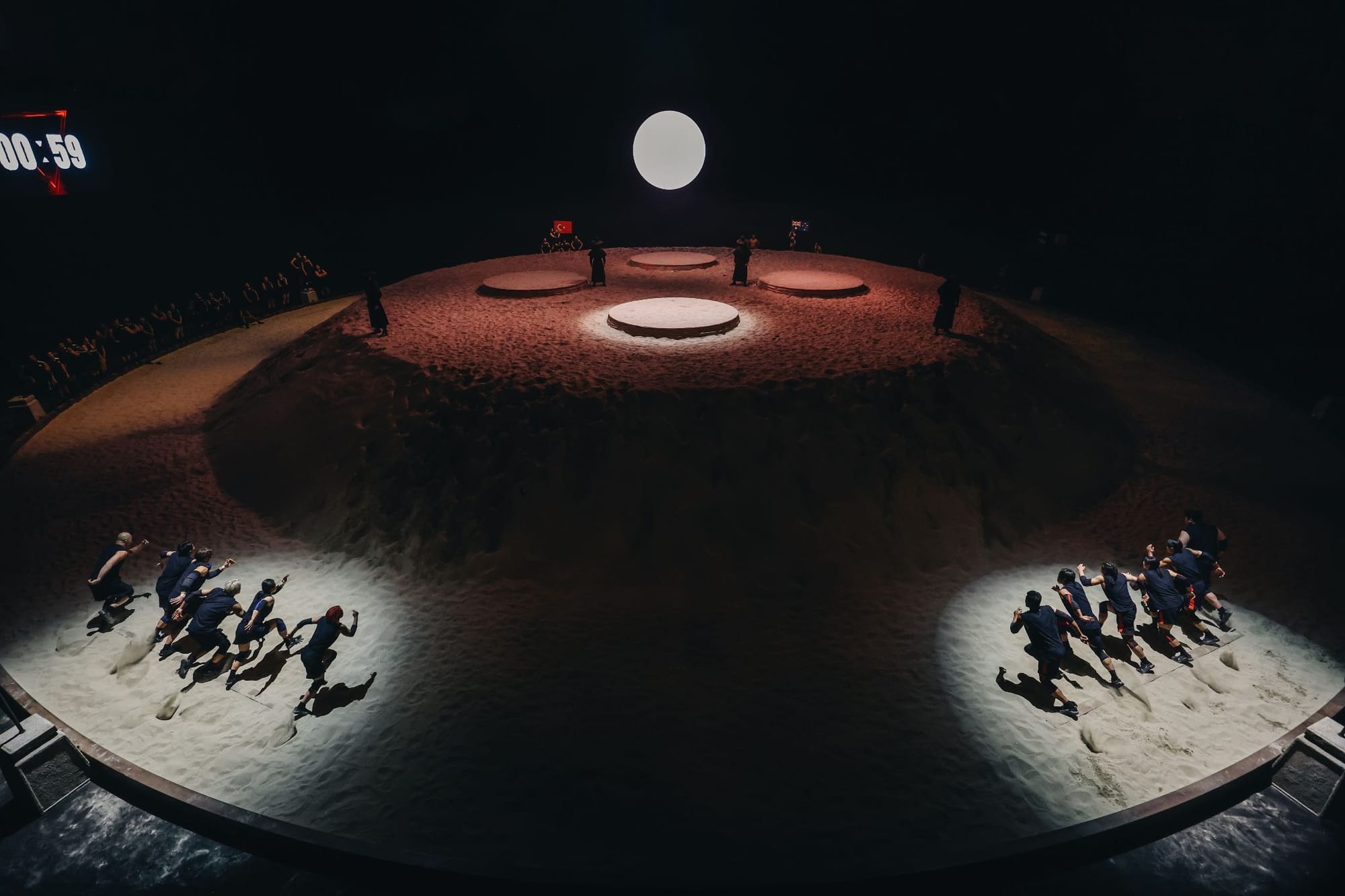 Teams race up a mound of sand in Physical Asia
