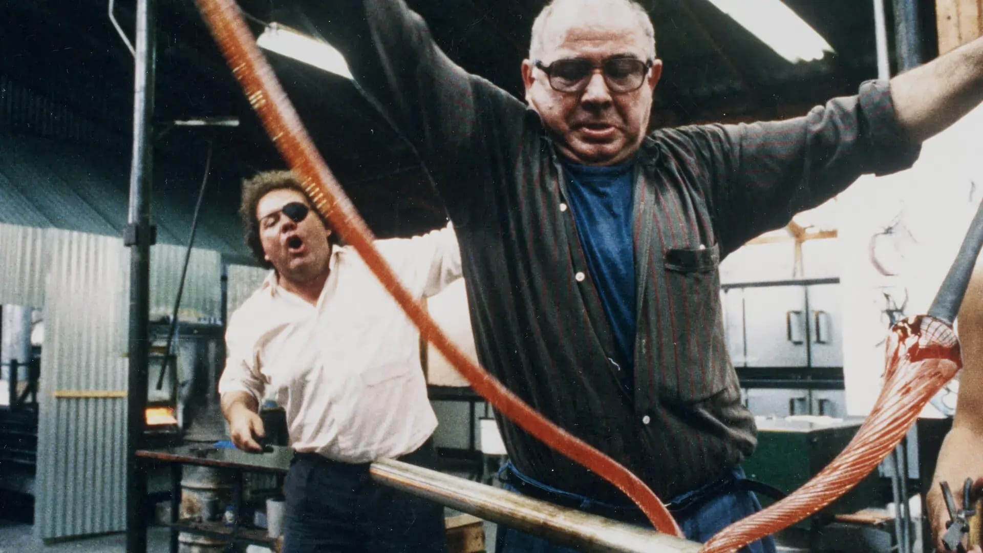 Lino and Dale Chihuly work on a glass piece together in Sono Lino