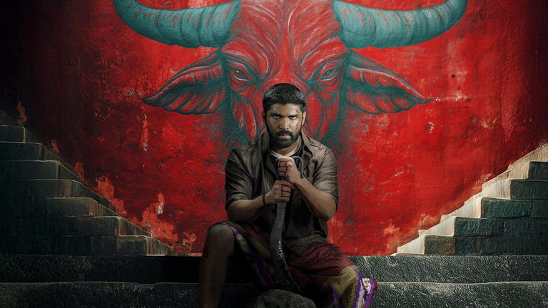 In Bison Kaalamaadan, Dhruv holds a blade with bloody hands while sitting on a staircase in front of a mural of a bison
