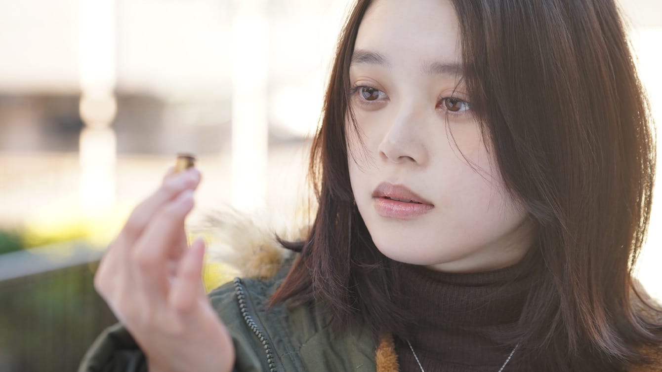 Akari Takaishi looks at a bullet casing in Ghost Killer