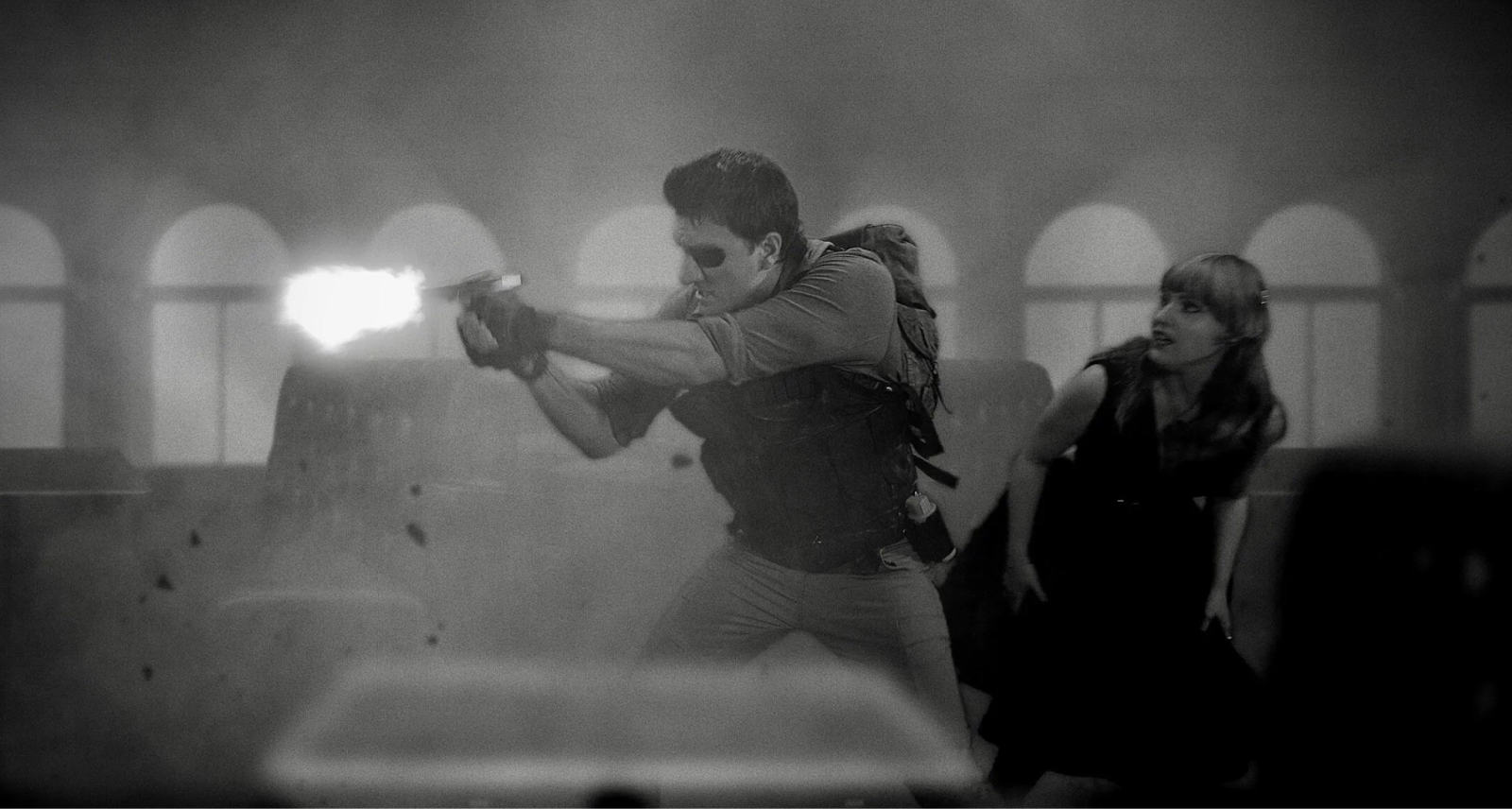 An eyepatch-wearing Jason Trost fires a gun in the side-scrolling movie Waves of Madness