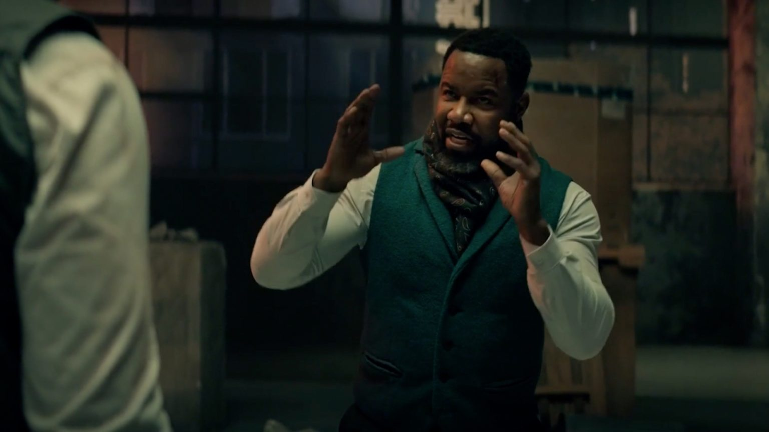 Michael Jai White gesticulates while he talks against a Volume background in Hostile Takeover