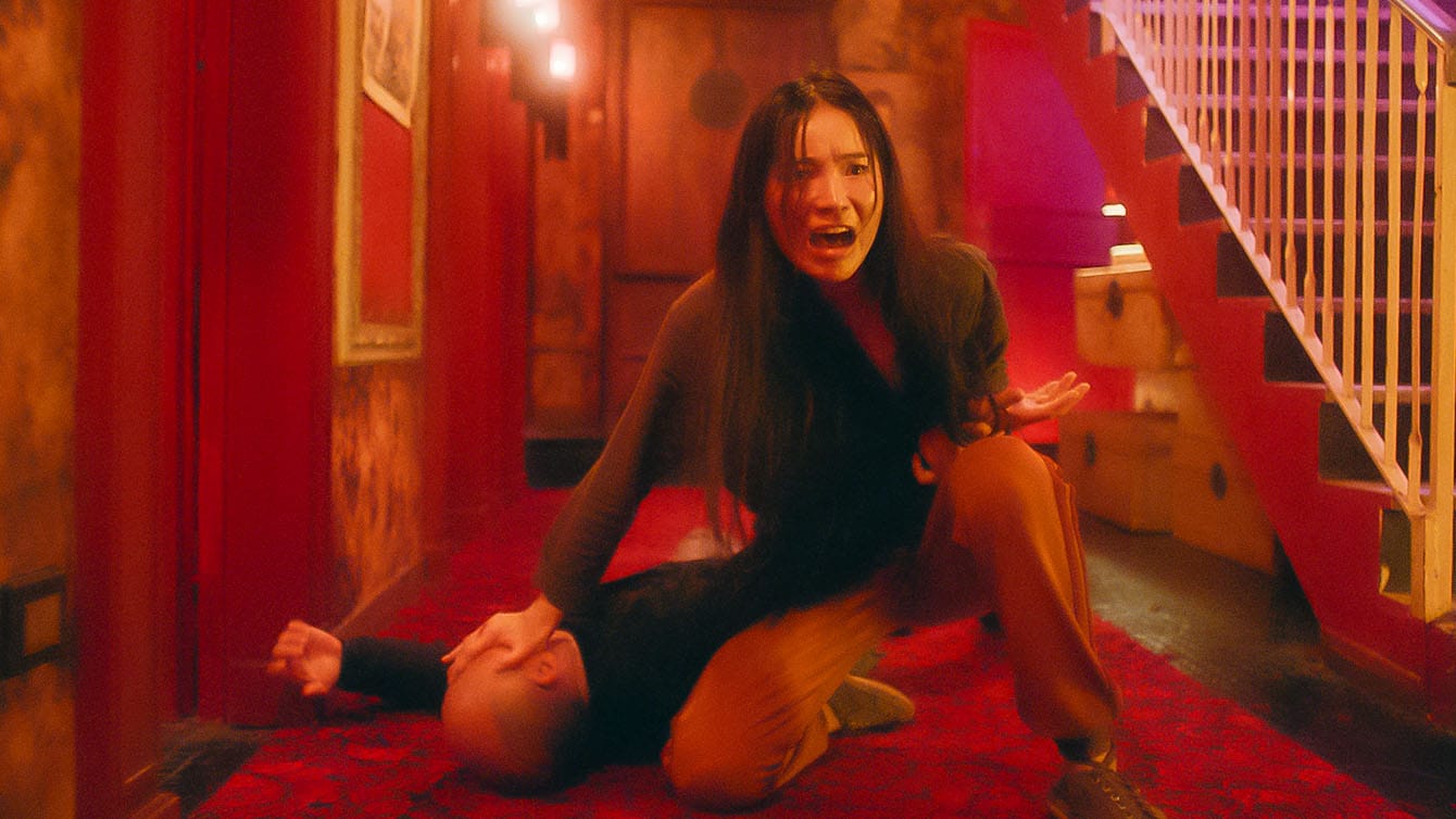 In The Forbidden City, Liu Yaxi holds a downed man by the wrist and face after taking him out