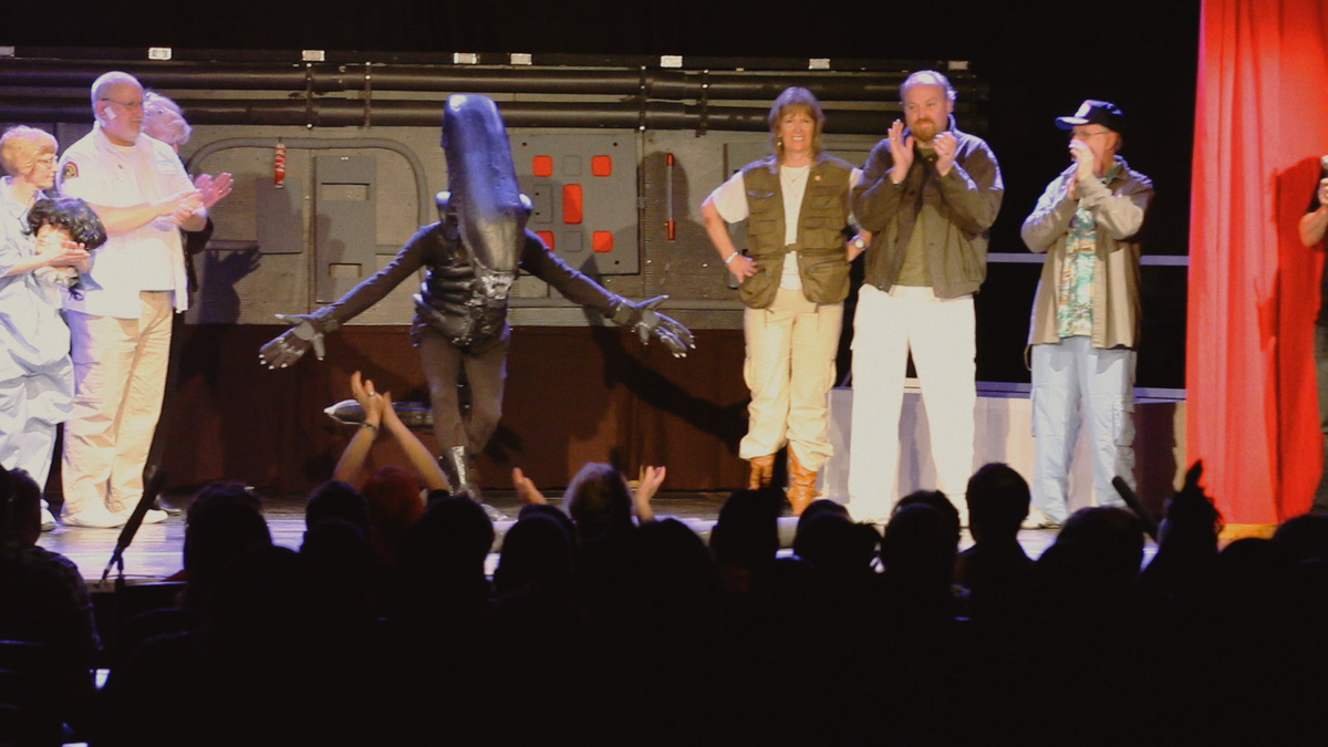In Alien on Stage, the crew of the Nostromo claps on stage as the Xenomorph bows to a cheering audience