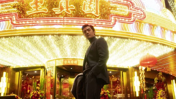Hu Ge looking very cool in front of a lit-up marquee in Blossoms Shanghai
