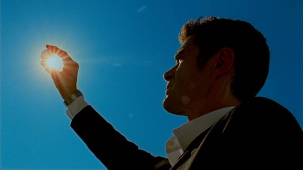 In Reflection in a Dead Diamond, Yannick Renier holds something up to the sunlight and squints