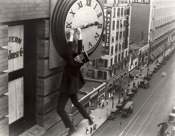 Harold Lloyd hanging from a clock in Safety Last!